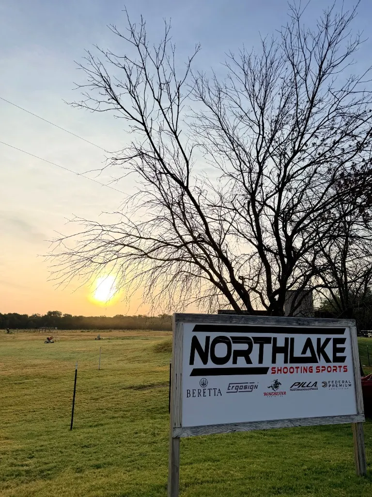The Northlake Shooting Sports sign at the range, with the course stretching toward the horizon.