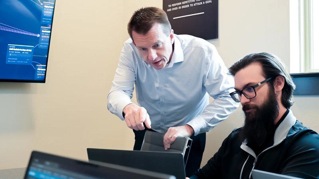 Three Aligned Technology Partners team members reviewing server and network inventory together at the Roanoke, Texas office